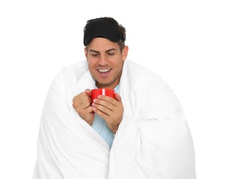 Photo of Man in sleeping mask wrapped with blanket holding cup on white background