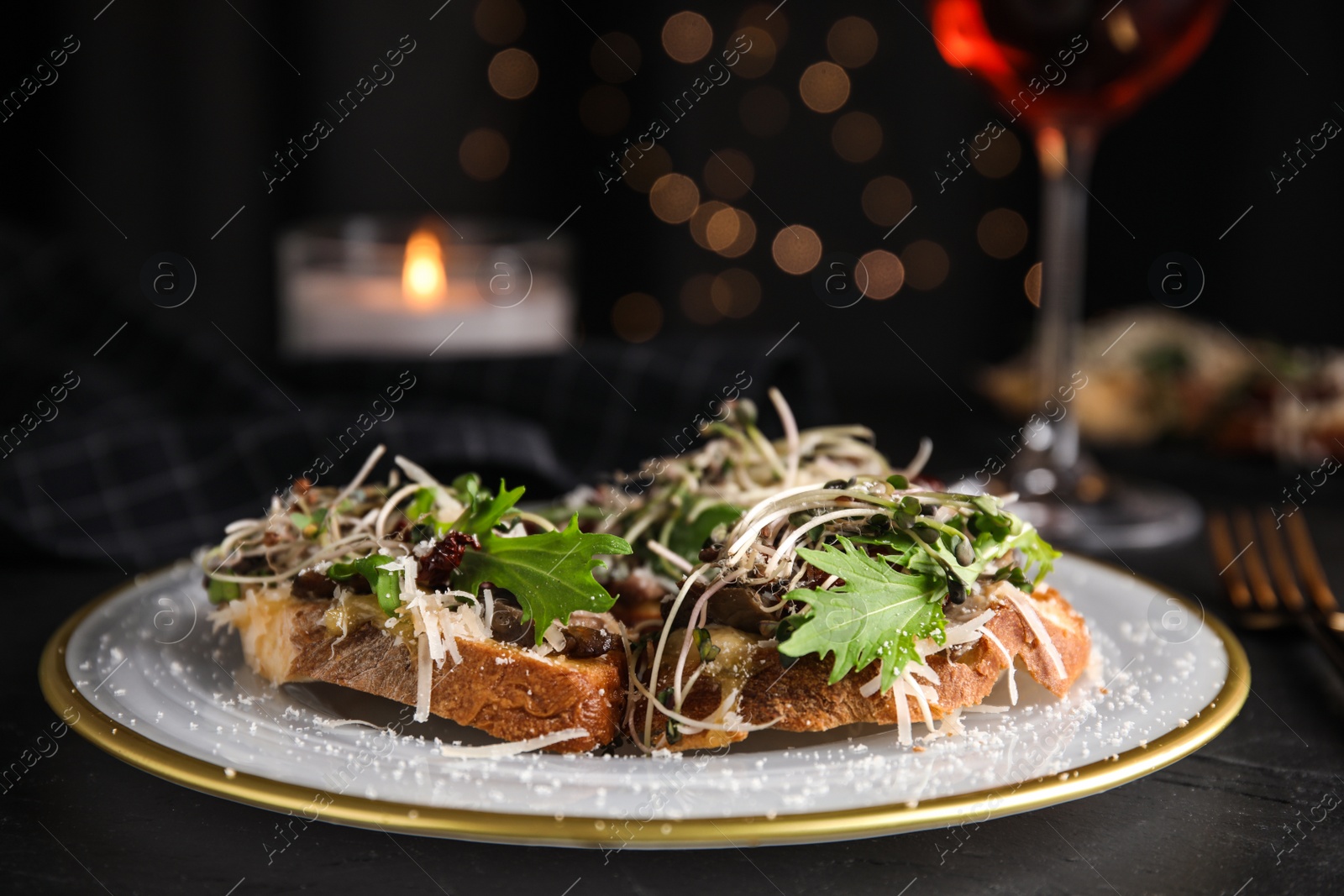 Photo of Delicious bruschettas with beef and cheese on black table
