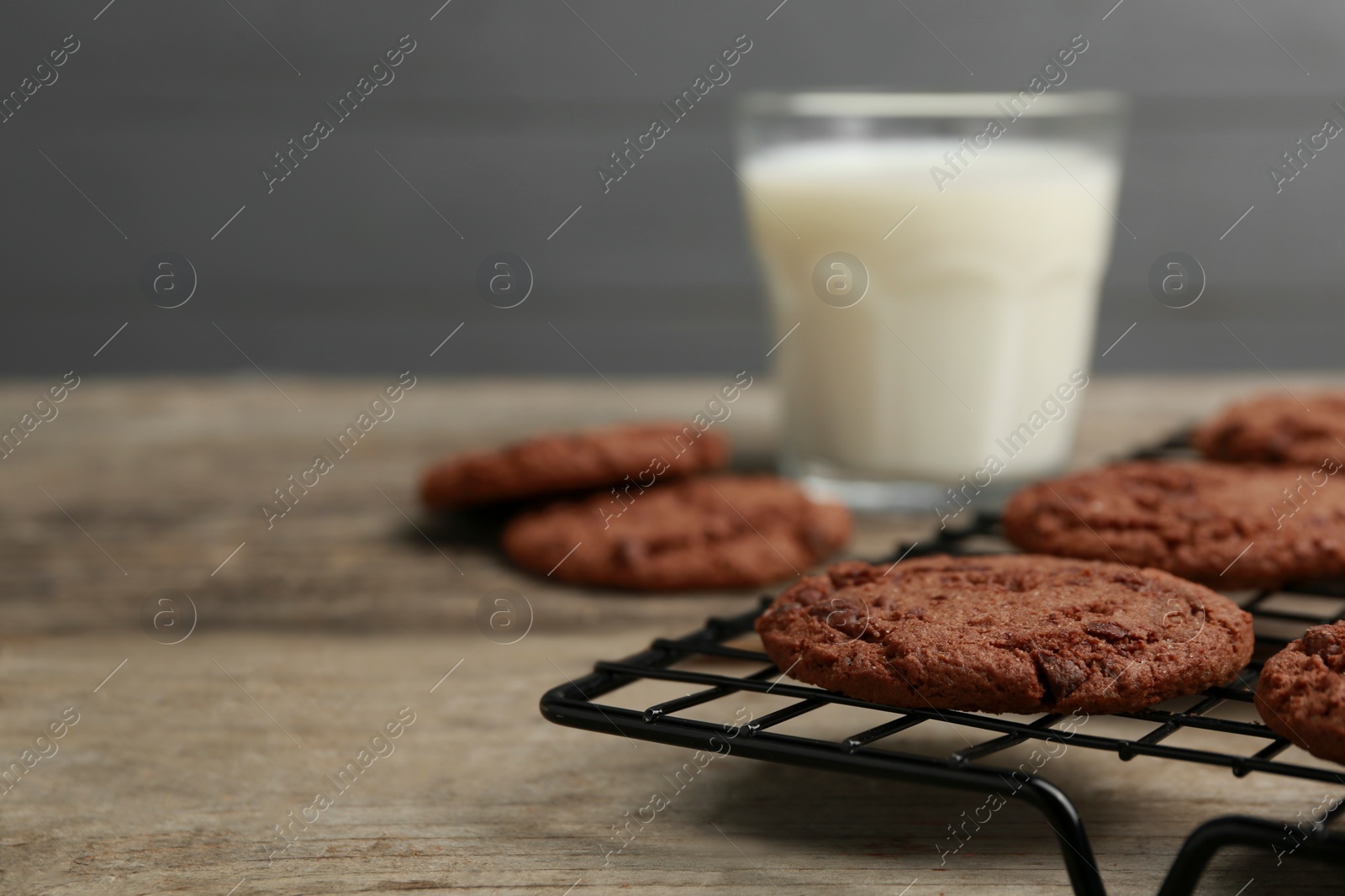 Photo of Delicious chocolate chip cookies on wooden table, closeup. Space for text