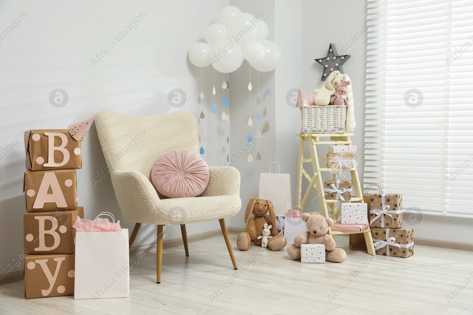 Photo of Baby shower party. Festive decor, gift boxes and toys in stylish room