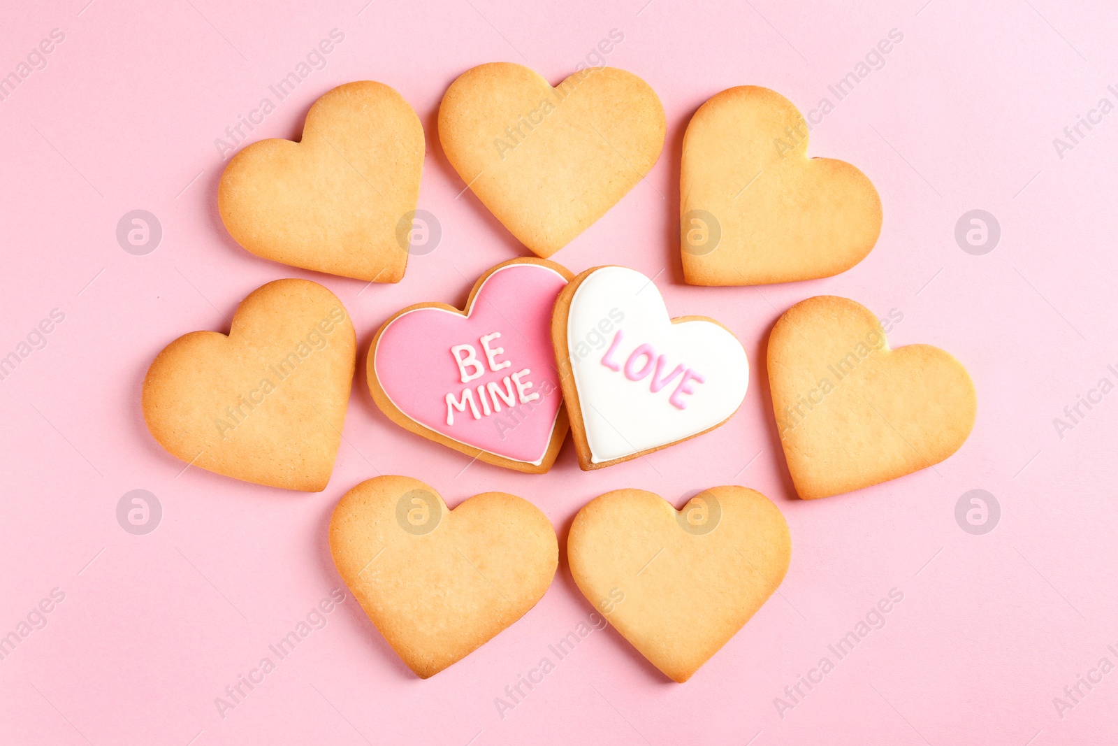 Photo of Decorated heart shaped cookies on color background, top view. Valentine's day treat