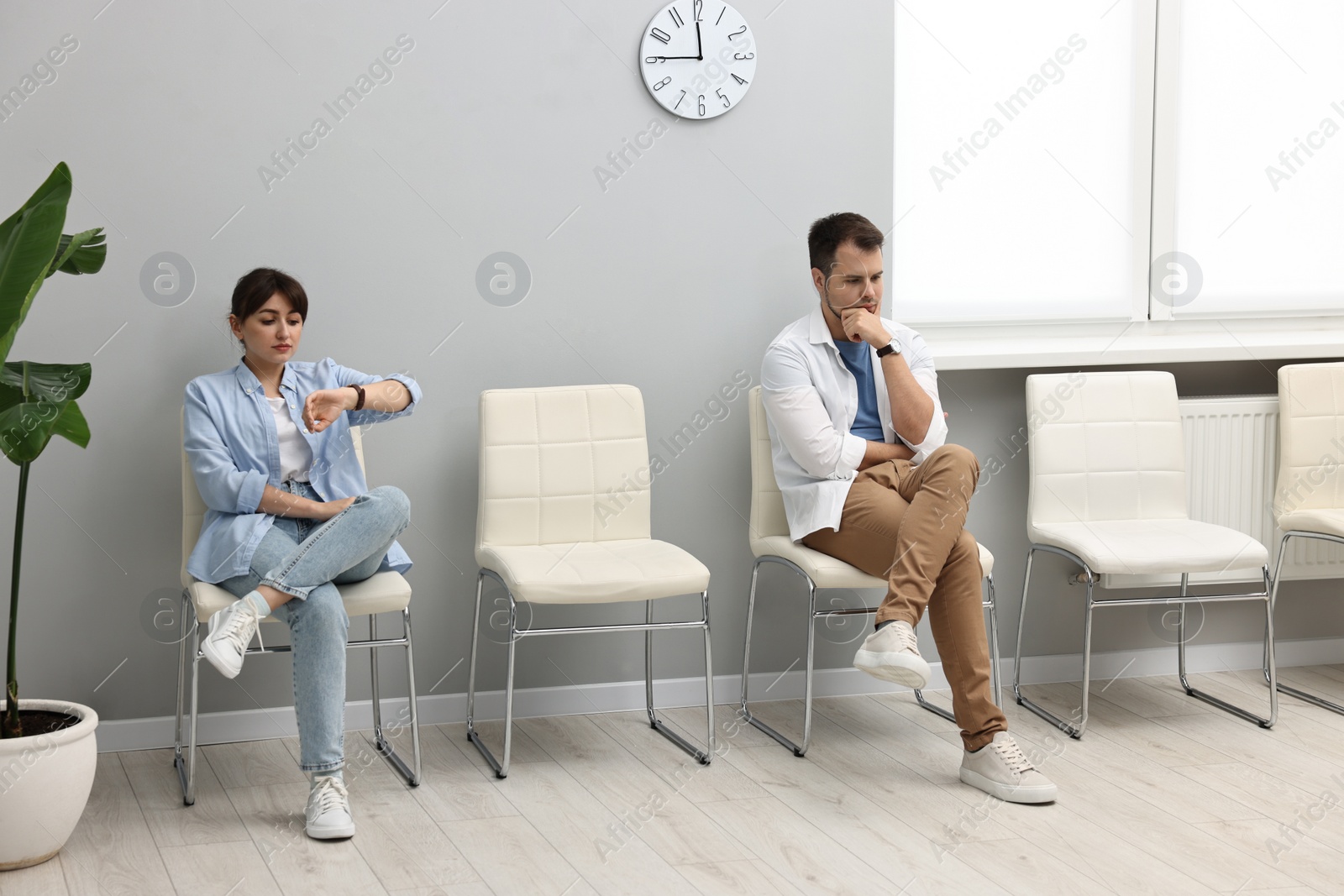 Photo of Man and woman waiting for appointment indoors