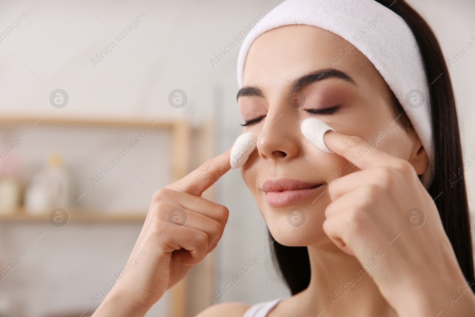Photo of Woman using silkworm cocoons in skin care routine at home, closeup