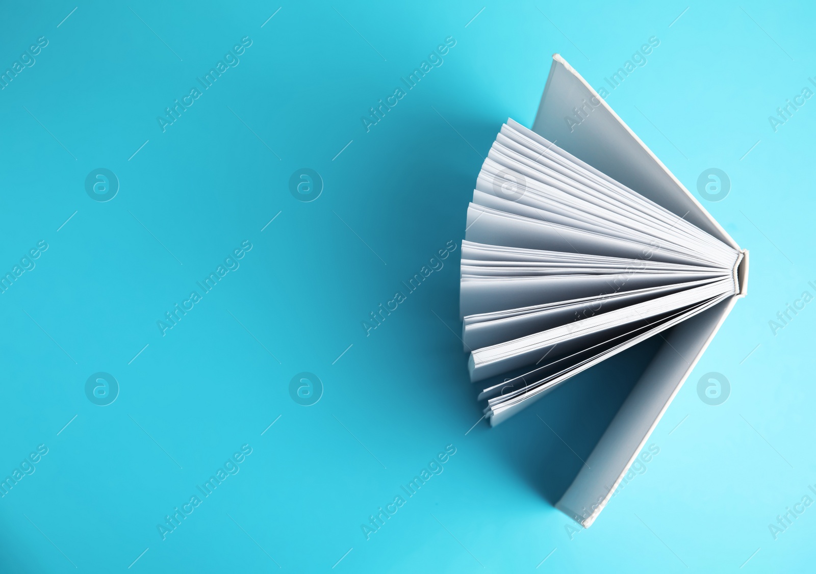 Photo of Hardcover book on blue background, top view. Space for text