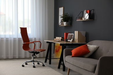Photo of Modern workplace with comfortable chair in stylish home office interior