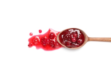 Photo of Wooden spoon with cranberry sauce on white background, top view