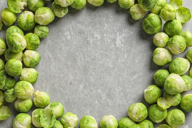 Photo of Frame made with Brussels sprouts on grey background, top view. Space for text