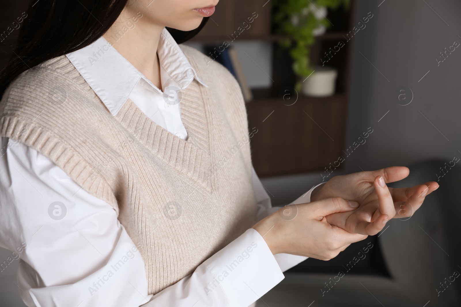 Photo of Woman suffering from trigger finger at home, closeup