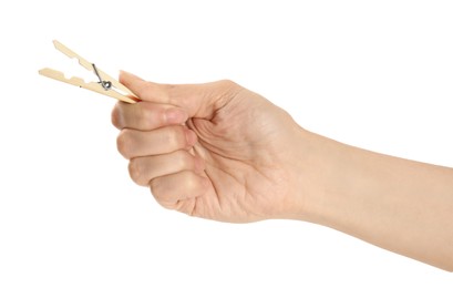 Photo of Woman holding wooden clothespin on white background, closeup