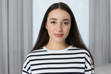 Photo of Portrait of beautiful young woman at home