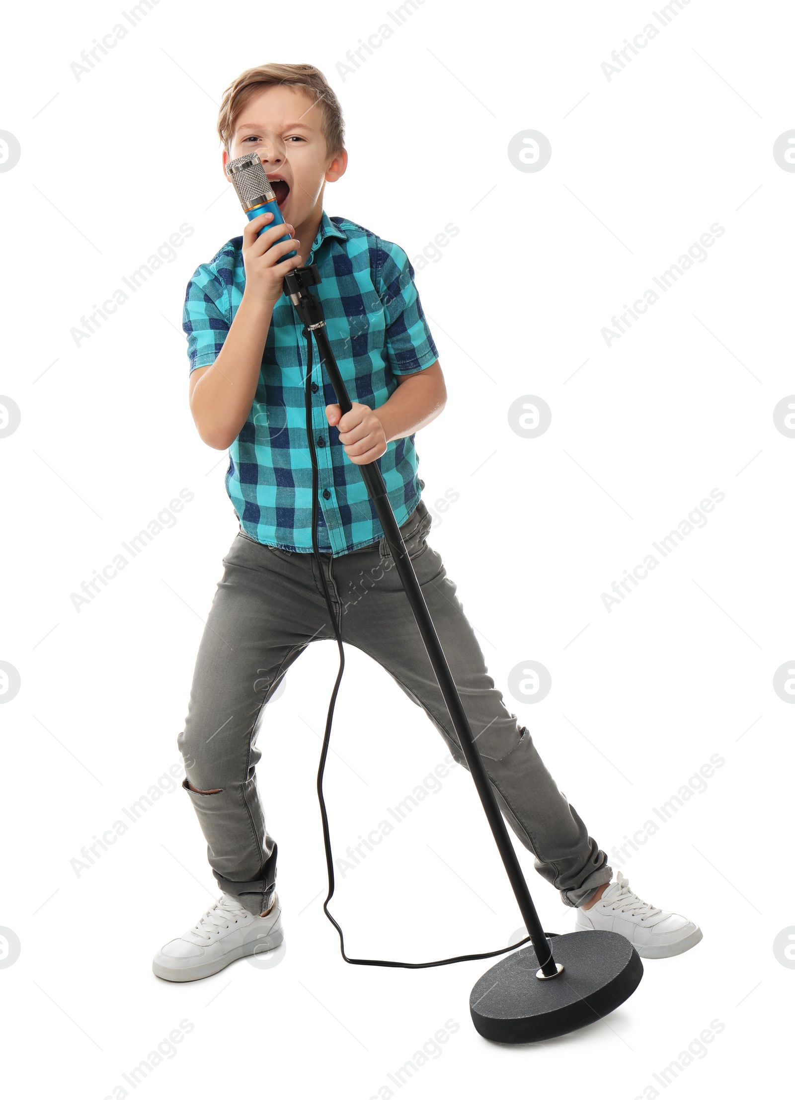 Photo of Cute boy singing in microphone on white background