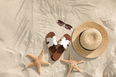 Photo of Flat lay composition with beach accessories on sand
