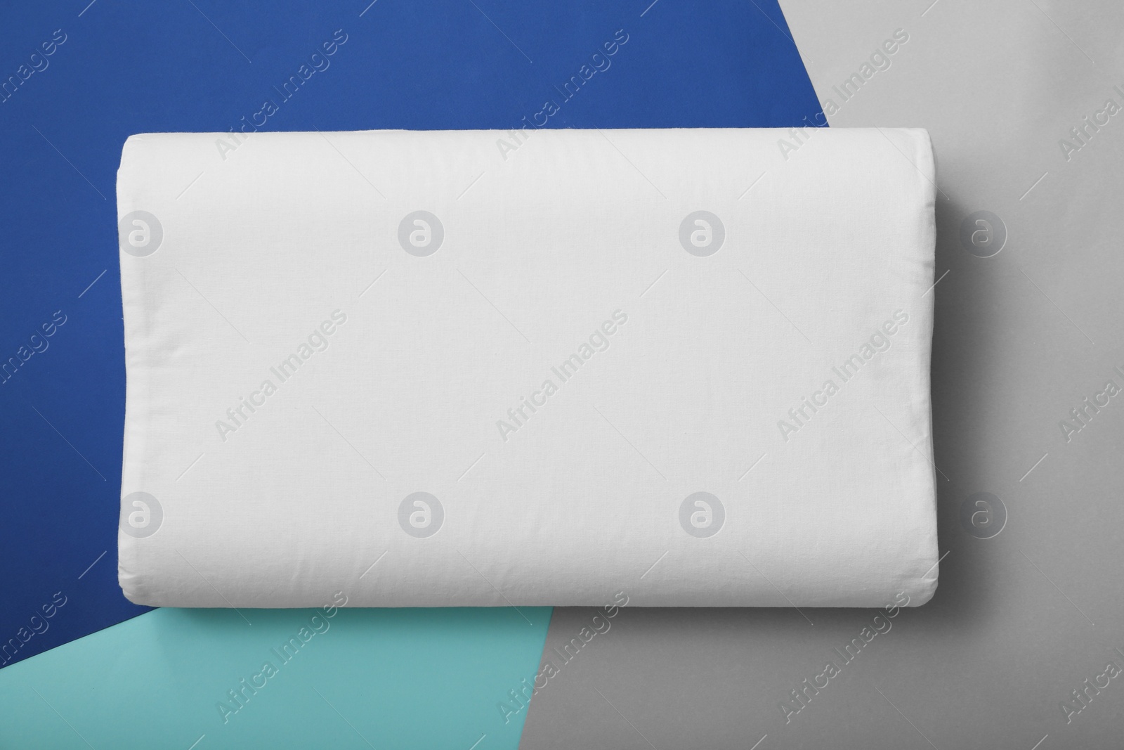 Photo of Soft bed pillow on color background, top view