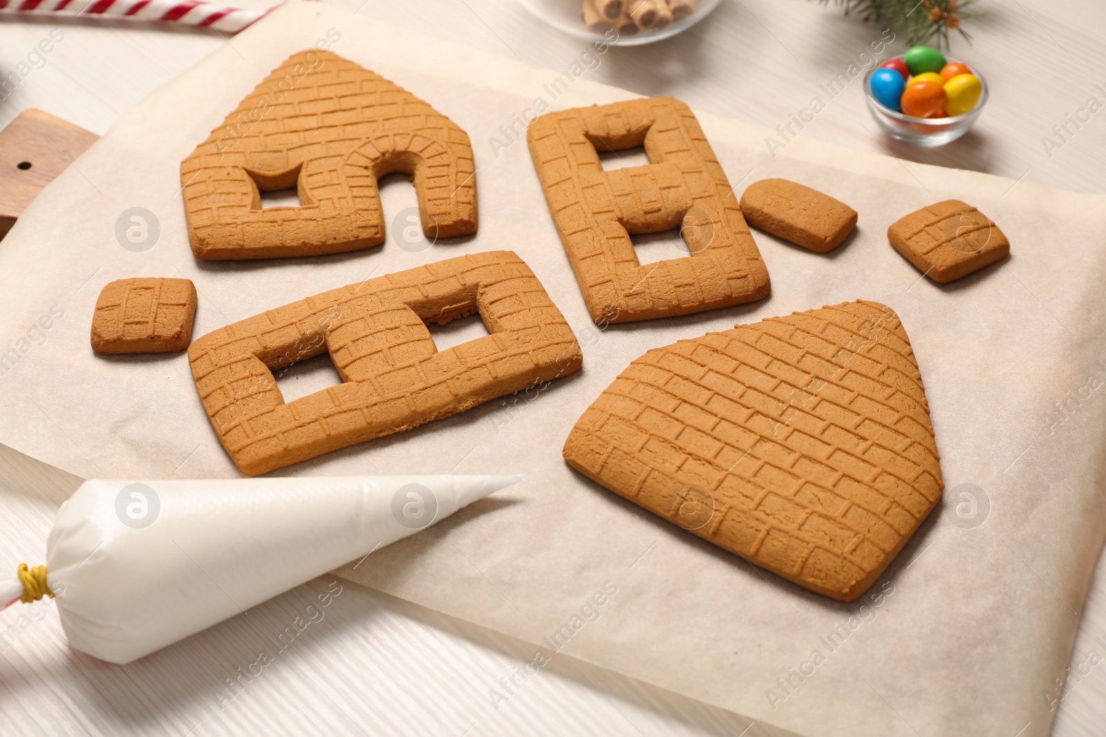 Photo of Parts of gingerbread house on white table