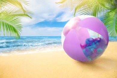 Image of Violet beach ball on sandy coast near sea, space for text 