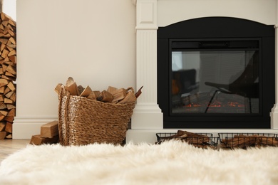 Basket with firewood on floor in room