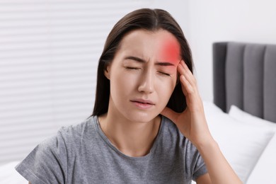 Image of Sad woman suffering from headache at home