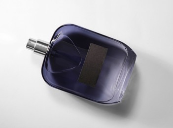 Photo of Luxury men`s perfume in bottle on white background, top view