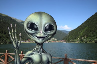 Image of Alien near lake in mountains. UFO, extraterrestrial visitors