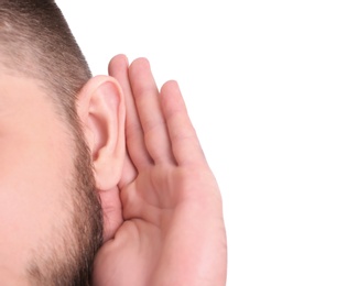 Photo of Young man with hearing problem on white background, closeup