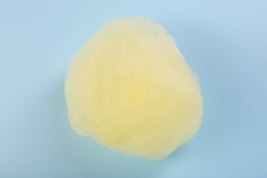 Photo of Sweet cotton candy on light blue background, top view