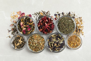 Photo of Flat lay composition with different dry teas on light table
