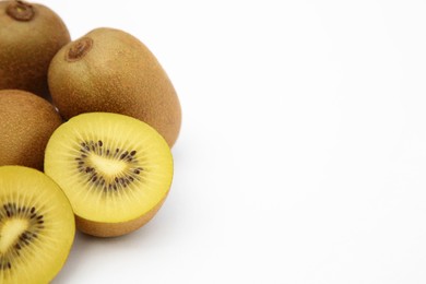 Photo of Whole and cut ripe yellow kiwis on white background