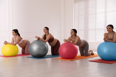 Photo of Group of pregnant women doing exercises in gym. Preparation for child birth