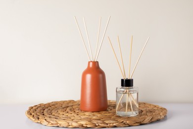 Photo of Aromatic reed air fresheners on white table