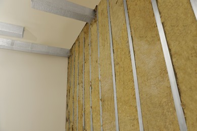 Photo of Wall with metal studs and insulation material indoors