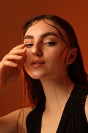 Photo of Portrait of beautiful woman on brown background