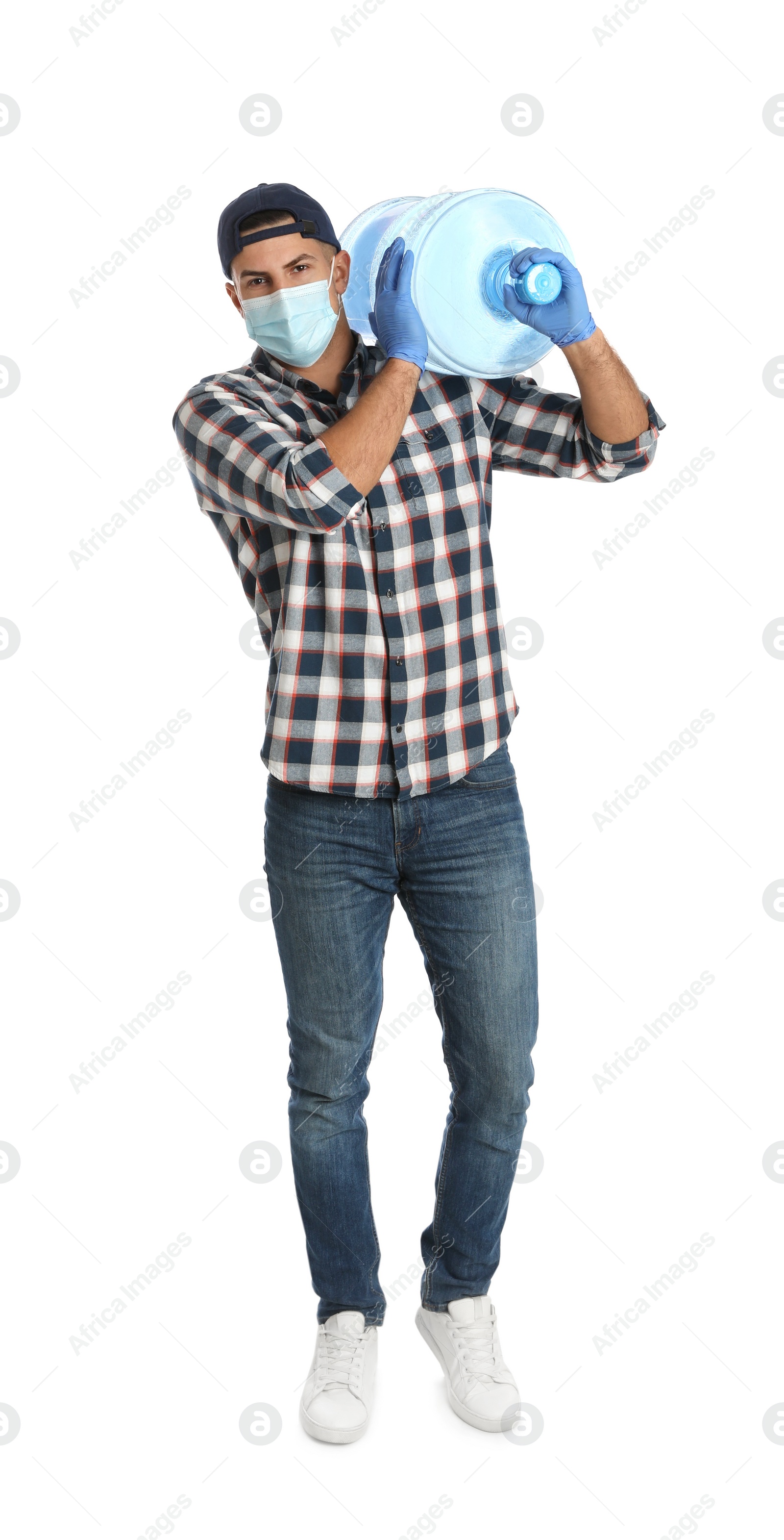 Photo of Courier in face mask with bottle of cooler water on white background. Delivery during coronavirus quarantine