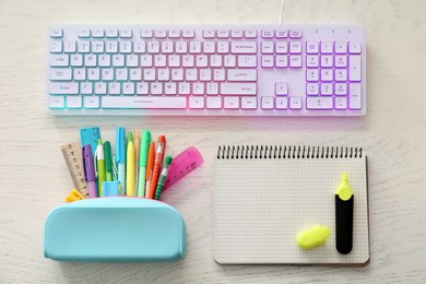 Photo of Flat lay composition with modern RGB keyboard on white wooden table