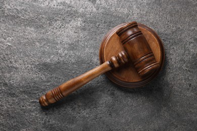 Photo of Law concept. Judge's gavel on grey textured table, top view