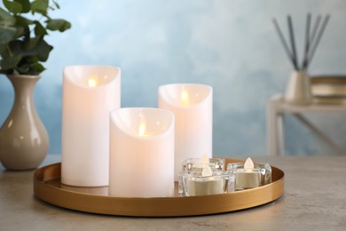 Photo of Beautiful decorative LED candles on grey table