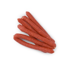 Photo of Thin dry smoked sausages isolated on white, top view