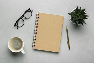 Photo of Flat lay composition with notebook on light textured table