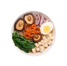 Photo of Delicious vegetarian ramen with egg, mushrooms, tofu and vegetables in bowl isolated on white, top view. Noodle soup