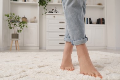 Photo of Woman standing on beige carpet in room, closeup. Space for text