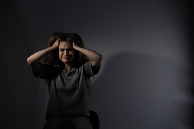 Photo of Depressed young woman on gray background