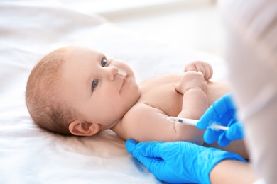 Photo of Doctor vaccinating baby in clinic