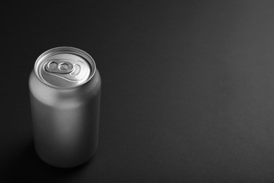 Photo of Can of energy drink on black background. Space for text
