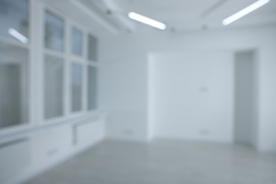 Photo of Blurred view of new empty room with windows