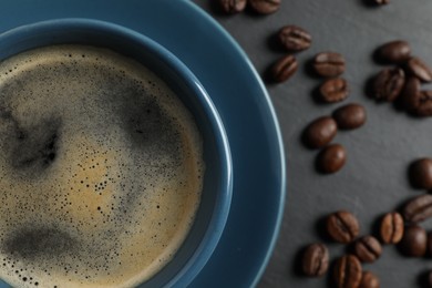Photo of Cup of aromatic coffee on grey table, top view. Space for text