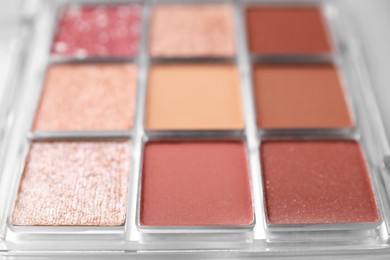 Beautiful eyeshadow palette as background, closeup. Professional cosmetic product