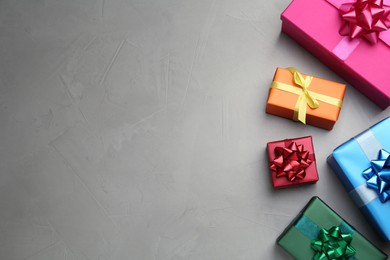 Photo of Many colorful gift boxes on light grey table, flat lay. Space for text