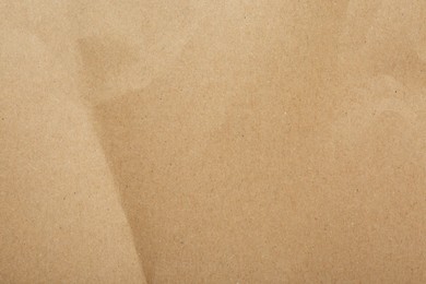 Photo of Kraft paper notebook sheet as background, top view
