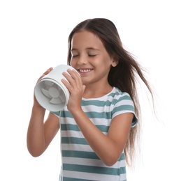 Photo of Little girl enjoying air flow from portable fan on white background. Summer heat