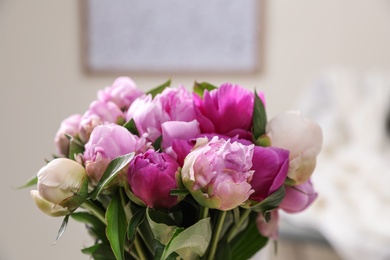 Photo of Bouquet of beautiful peonies in room, closeup