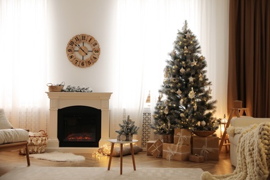 Photo of Beautiful living room interior with decorated Christmas tree and modern fireplace